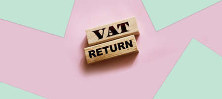 VAT return text Value Added Tax return on wooden blocks on pink background. financial conceptの写真素材