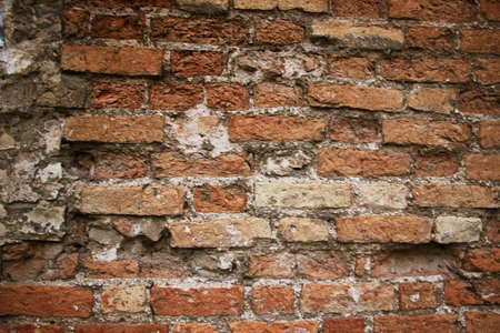 Weathered historical old red brick wall texture. Vintage background.の写真素材