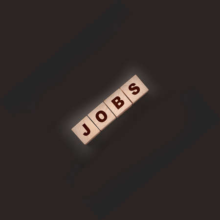 Text JOB on wooden cubes on a black background. freelance career business concept.の写真素材