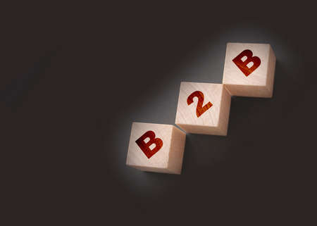 Three wooden cubes with letters B2B - stands for Business to Business on black. Marketing concept.の写真素材