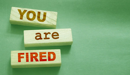 You are fired written on a wooden blocks with copyspace. Crisis labor force cut business concept.の写真素材