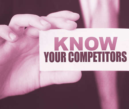 Businessman putting a card with text know your competitors. Business concept.の写真素材