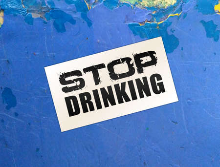 Stop drinking words on card on wooden table. Addictions healthcare concept.の写真素材