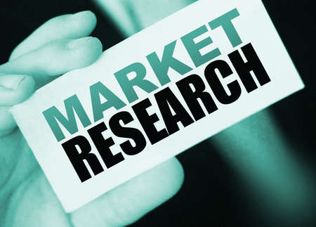 Businessman shows card with text Market Research. Business concept.の写真素材