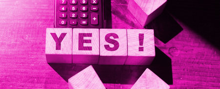 The word Yes on wooden blocks and calculator. Business, motivation and education concept.の写真素材