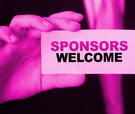 Businessman shows a card with text Sponsors Welcome. Fundrising sponsorship concept.の写真素材
