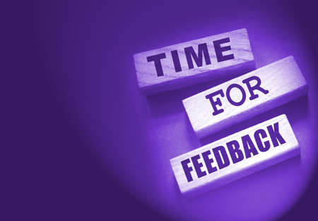 Time fir feedback text on wooden blocks. Product or service evaluation and clients feedback in...