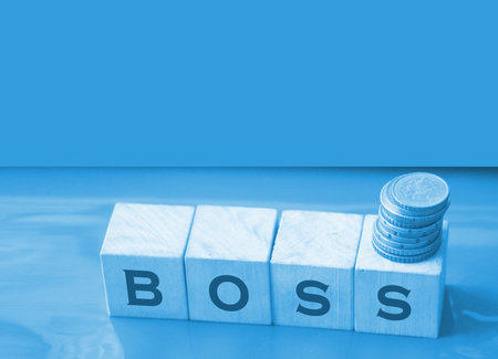 The boss sign on a wooden cubes on black. Business owner concept.の写真素材
