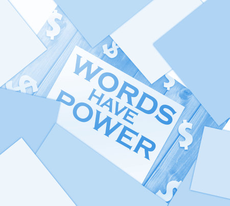 Words have power text on page and paper dollar signs around on wooden table. Copywritting storytelling marketing concept.の写真素材