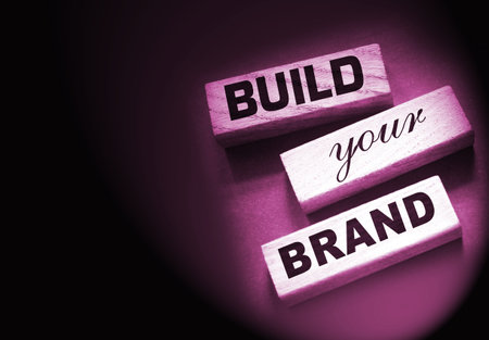 Phrase BUILD YOUR BRAND written on wooden blocks. With vintage styled background. Branding rebranding marketing conceptの写真素材