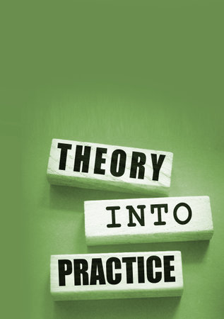 Theory into practice words written on wooden blocks. Education or business startup concept.の写真素材