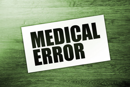text MEDICAL ERROR words on a card on wooden table. Medical healthcare conceptの写真素材