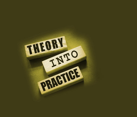 Theory into practice words written on wooden blocks. Education or business startup concept.の写真素材