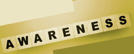 Awareness alphabet letter on wooden cubes on green background. Saving nature eological concept, healthcare concept.の写真素材