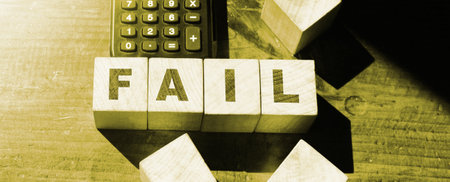 Fail word from wooden blocks and calculator on desk. Business crisis concept.の写真素材
