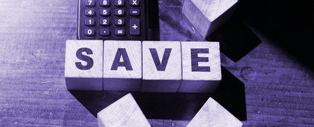 Word Save. Save text on wooden blocks and calculator. Business Concept Image.の写真素材