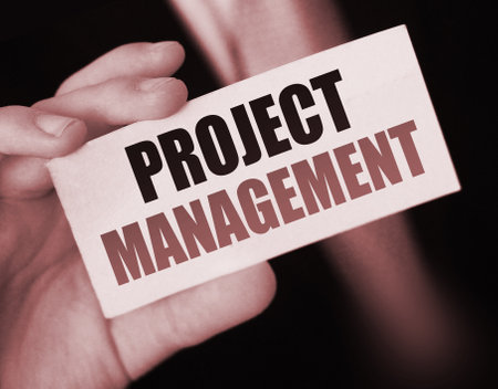 PROJECT MANAGEMENT words on card businessman holds. Bbusiness concept.の写真素材