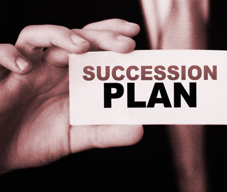 Succession Plan words on a card in hand of businessman. Business profit and success concept.の写真素材
