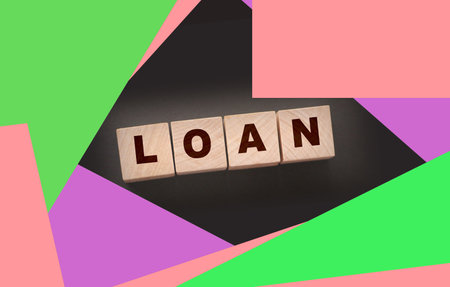 Wooden cubes with loan word on black. Business conceptの写真素材