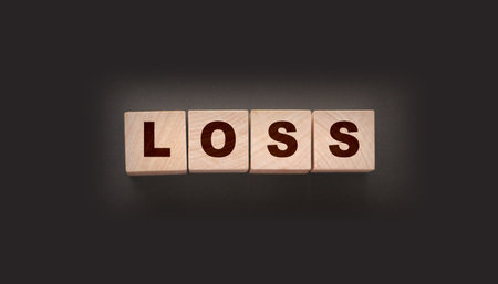 Wooden cubes with LOSS word on blacktable. Financial loss busines conceptの写真素材