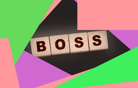 The boss sign on a wooden cubes on black. Business owner conceptの写真素材