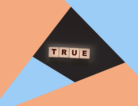 concept word true on wooden cubes on black backgroundの写真素材