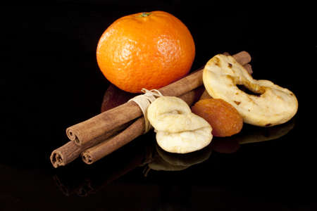 Cinnamon and dried fruits ona black backgroundの写真素材