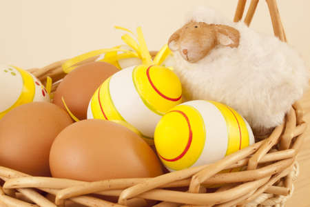 Easter eggs and sheep in basketの写真素材