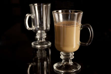 Coffee frappe in a tall glass on a black backgroundの写真素材