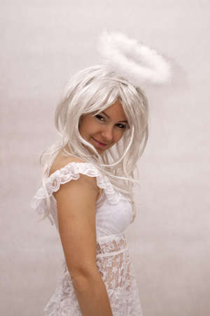 Sexy woman dressed as angel on a white backgroundの写真素材