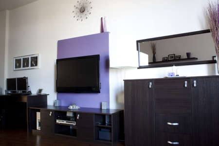 Living room with a purple wall of TV の写真素材