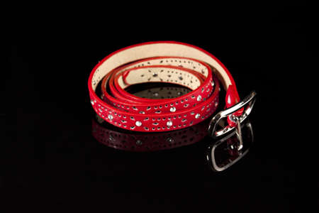 Red narrow belt on the black backgroundの写真素材