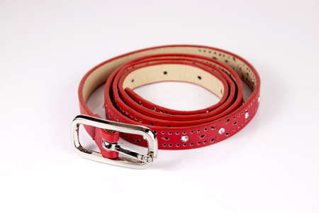 Red narrow belt for women on the white backgroundの写真素材