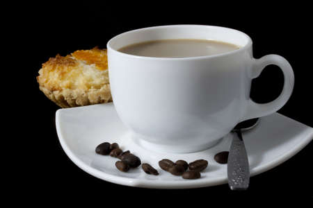 White coffee with tasty cake on a black backgroundの写真素材