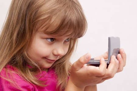 A pretty girl with a small mirrorの写真素材