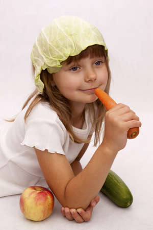 Pretty girl with carrot, cucumber and appleの写真素材