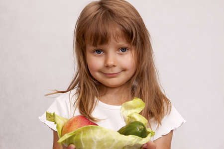  Girl with vegetables - carrots, cabbage and cucumber の写真素材
