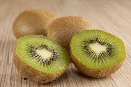 Green kiwi in half lengthwiseの写真素材