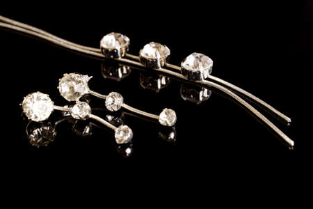 Silver chain and earrings on a black backgroundの写真素材
