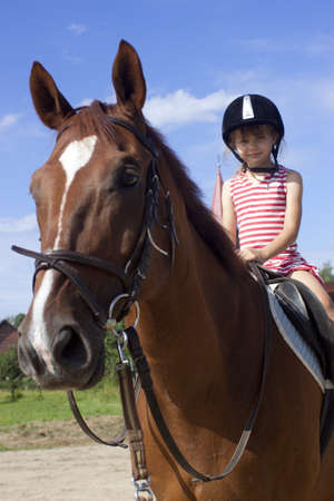 Little girl riding a horseの写真素材