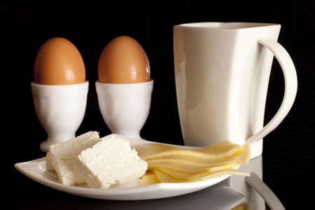 Dairy products for breakfast on a black backgroundの写真素材