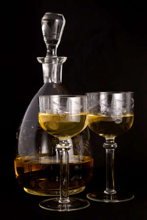 Honey vodka in a carafe and glassesの写真素材