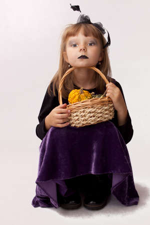 Painted girl with pumpkins for Halloweenの写真素材