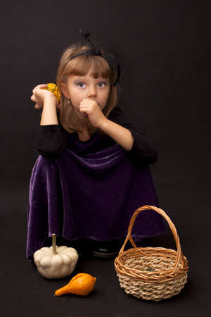 Preety girl with pumpkins on a black backgroundの写真素材