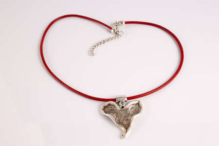 Silver heart on a red thongの写真素材