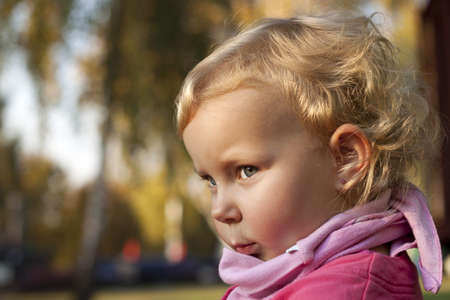 Beautiful child in autumn parkの写真素材