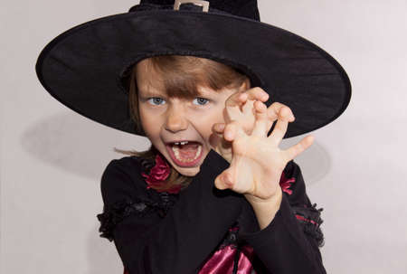The girl in a black hat with a terrifying expressionの写真素材