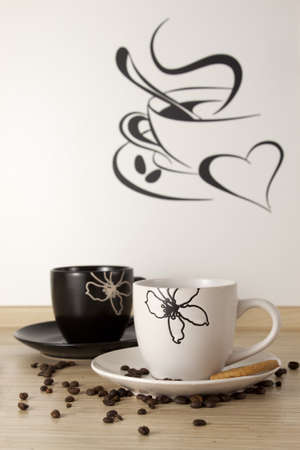 Two cups of coffee in the kitchen of the sticker on the wallの写真素材