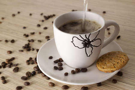 A cup of black coffee with cakeの写真素材