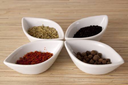 Condiments in white small bowlsの写真素材
